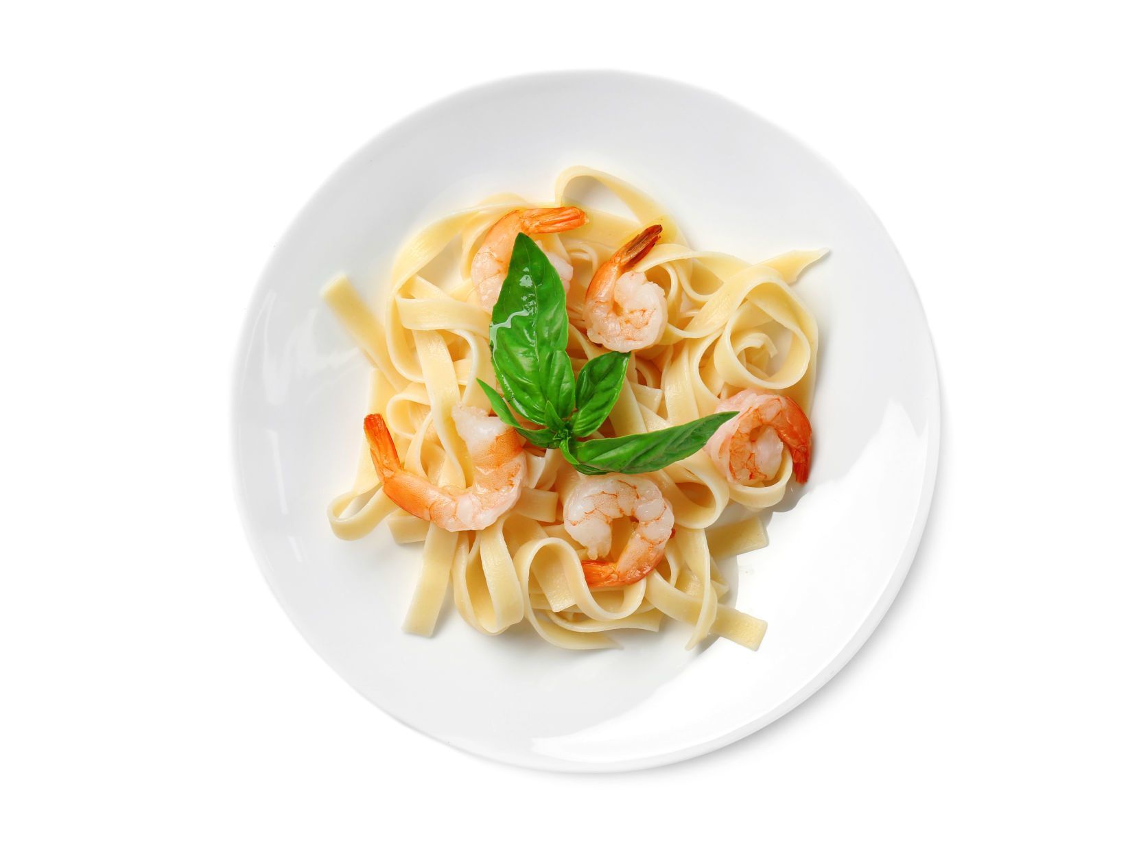 Plate of tasty pasta with shrimps on white background, top view